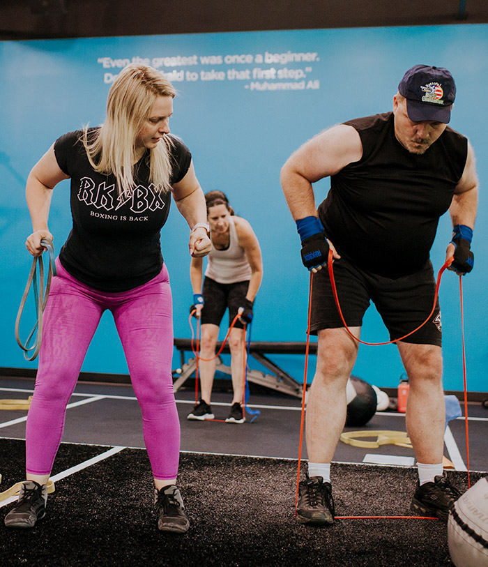 woman and man working out with resistance bands