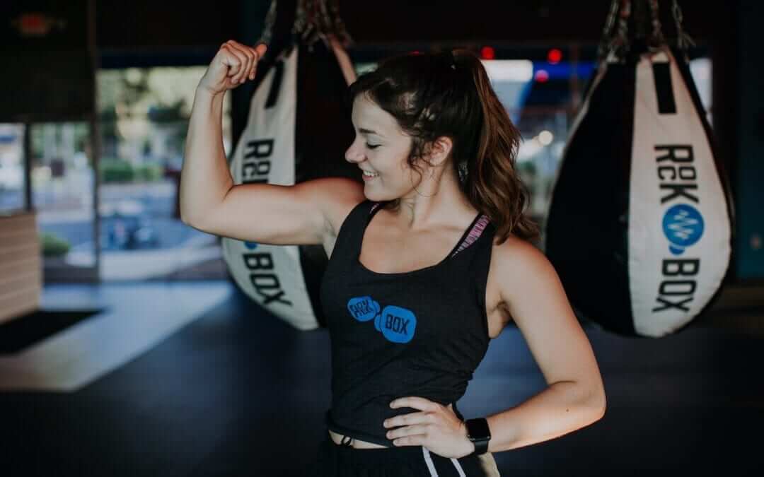 Woman flexes her bicep