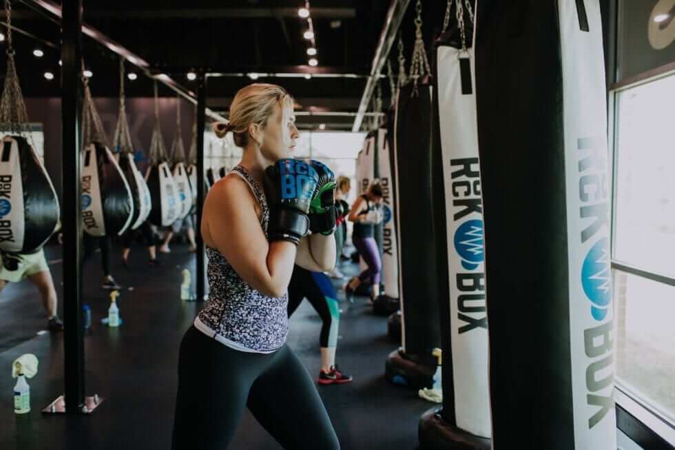 Woman poses prepared to hit a punching bag