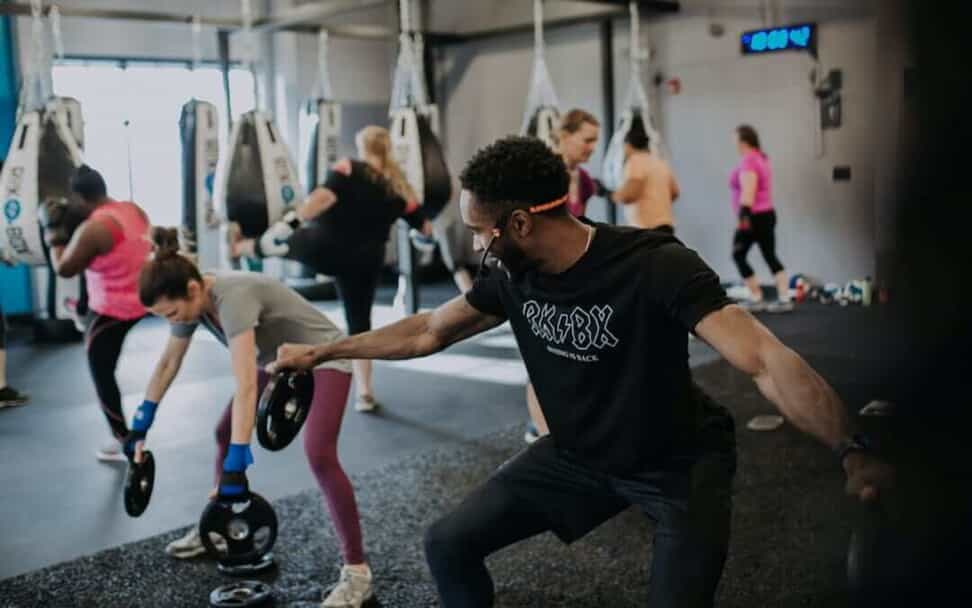 Coach demonstrates a workout with weight plates