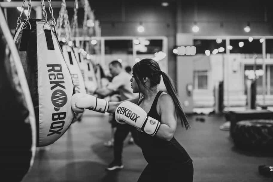 Woman punches a rockbox punching bag