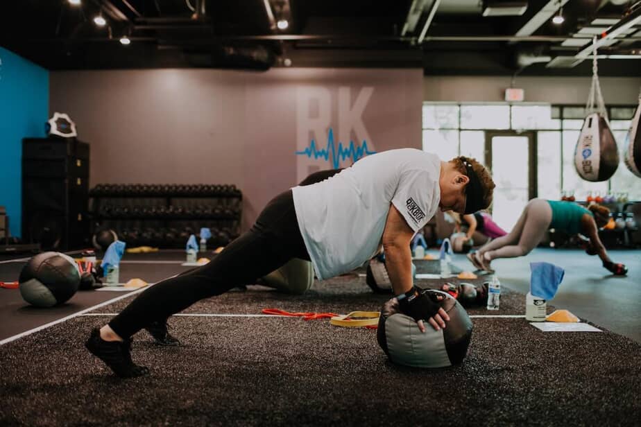 Woman does a push up on a medicine ball