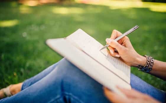 A woman writes in a journal