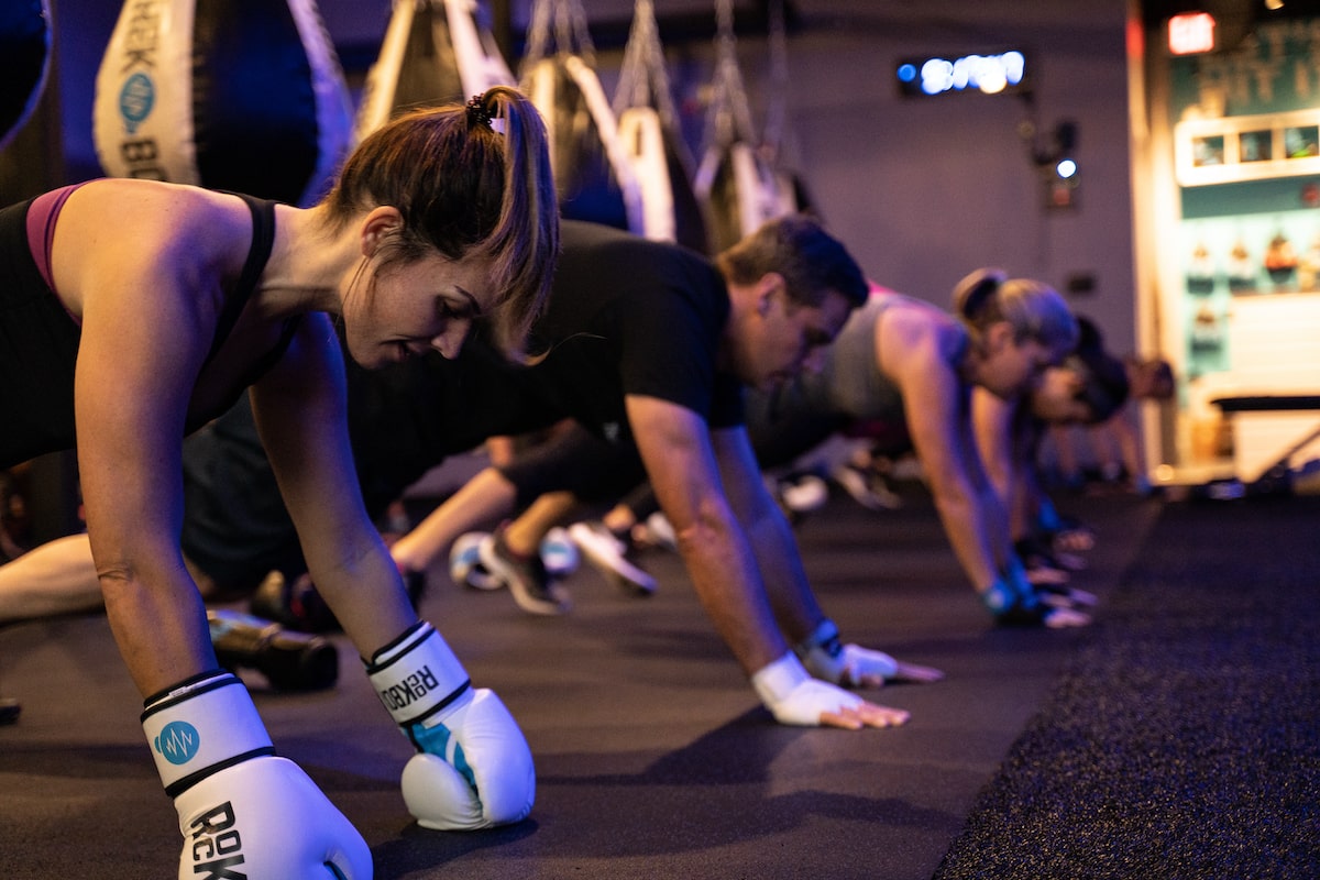 rockbox fitness trainer guiding the class to do pushups