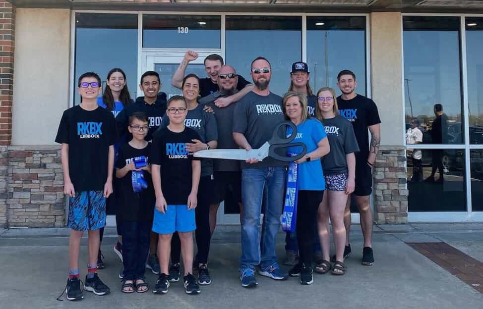 The Lubbock RockBox team standing outside the building at a ribbon cutting ceremony