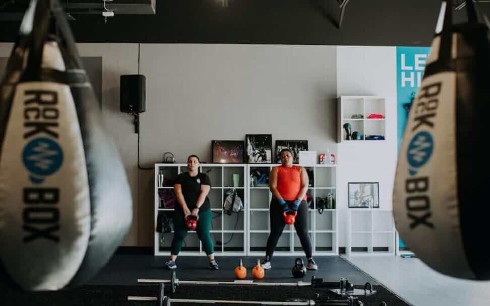 Two women workout with kettlebells