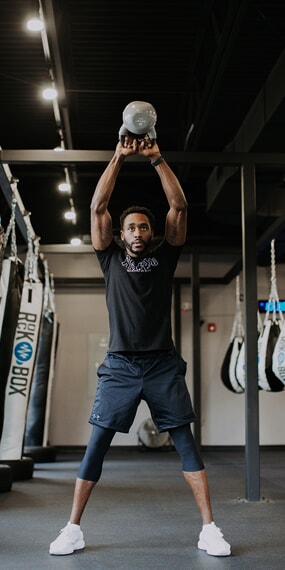 a rockbox member swings a kettlebell