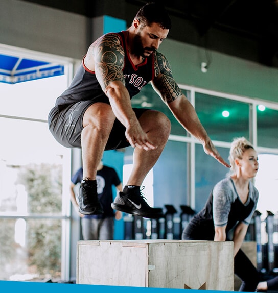 A male performs a box jump